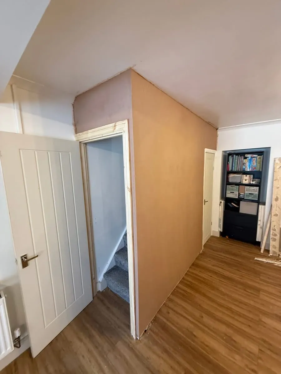 Freshly plastered wall to a domestic staircase, alongside new wood architrave